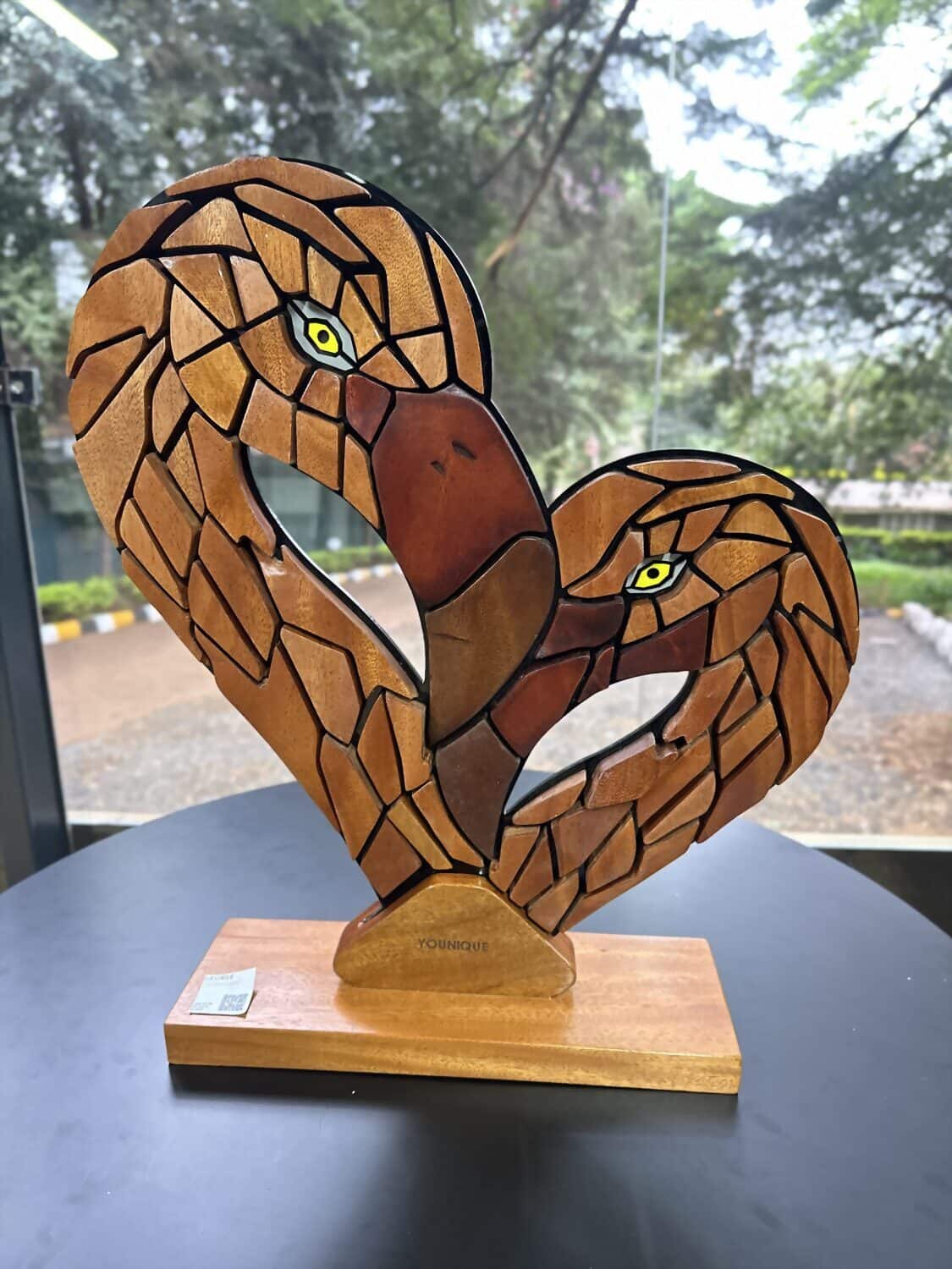 A wood mosaic of two flamingos forming a heart, on show at The Yard